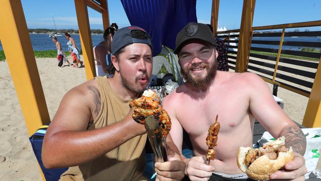 Gold Coast celebrates Australia Day at Broadwater parklands at Southport. Markus Saiat and Connor Betts from Beenleigh tucking in to some food... . Picture Glenn Hampson