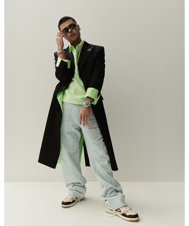 Coat, shirt, and jeans, all by Versace; sneakers by Dior Men; Fog sunglasses by Rick Owens at Harrolds; brooch, bracelets, bangles, and ring, all by Tiffany & Co..