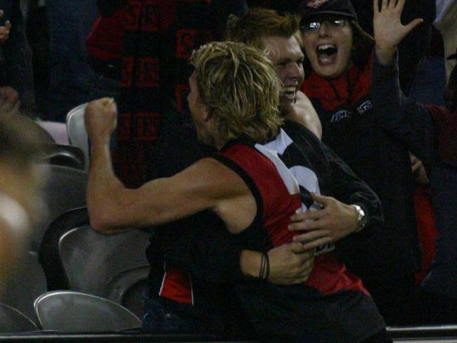 Footballer James Hird hugging with fan supporter after kicking winning goal.AFL football - Essendon vs West Coast Eagles match at Telstra Dome 10 Apr 2004.