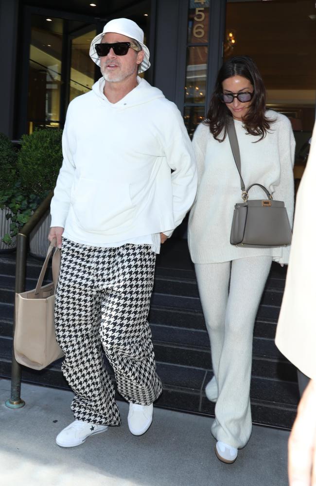 Matching outfit rating: 7/10. Brad breaks with the all white theme with his black and white herringbone pants. Picture: Vegan/Backgrid