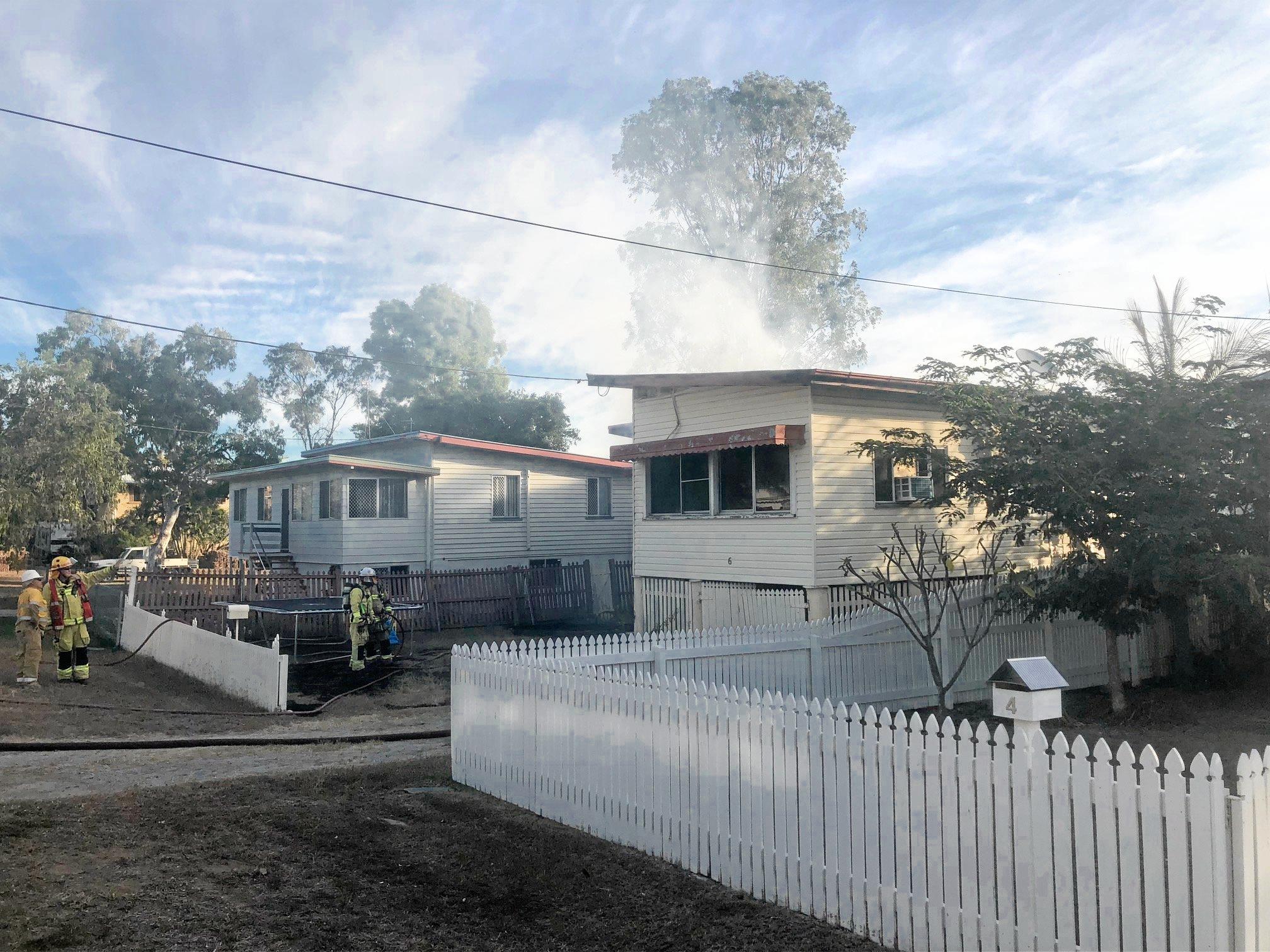 Firefighters at the scene of a house fire on Naughton St, Wandal, this afternoon. Reports indicate the top part of the house is gutted but firefighters are walking in through the front door.