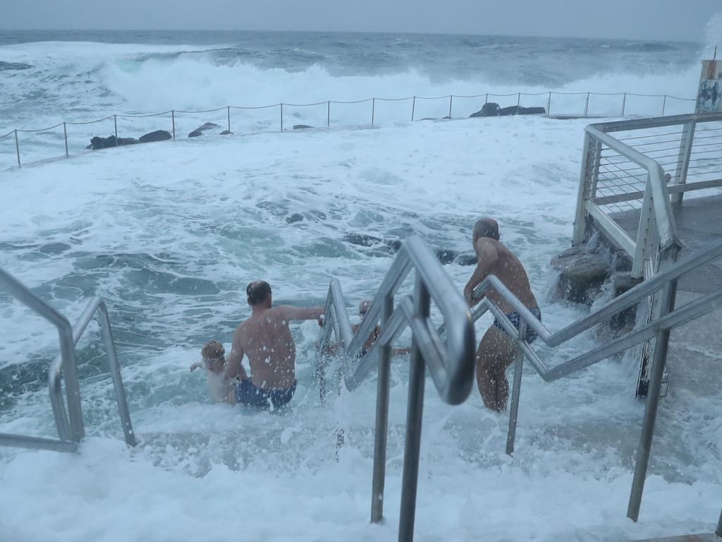 Swimmers braved the waves in Bronte pool about before lifeguards closed it. Picture: John Grainger