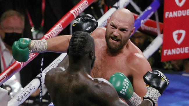 LAS VEGAS, NEVADA - OCTOBER 09: Tyson Fury (top) throws a right just before knocking out Deontay Wilder in the 11th round of their WBC heavyweight title fight at T-Mobile Arena on October 9, 2021 in Las Vegas, Nevada. (Photo by Ethan Miller/Getty Images)