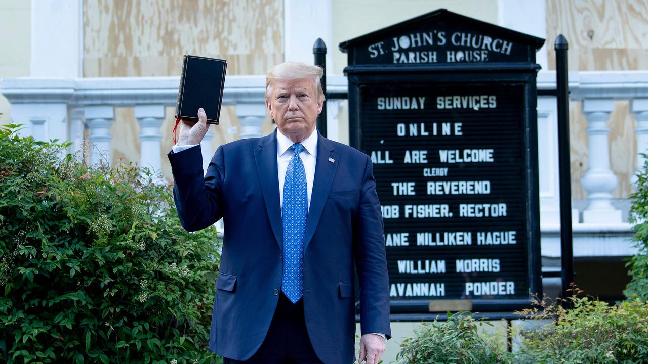 US President Donald Trump holds a Bible outside St John's Church across from the White House after the area was cleared of people protesting the death of George Floyd. Picture: Brendan Smialowski / AFP.