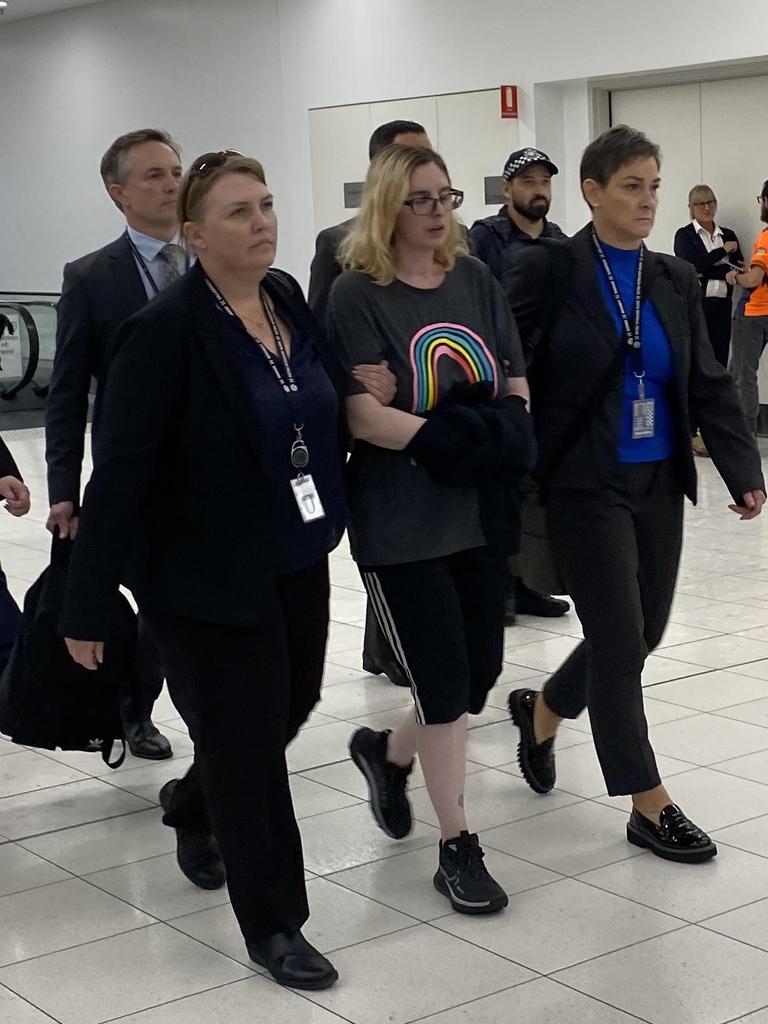 Police escort murder plot accused Lisa Lines through Adelaide Airport on Friday. Picture: Agnes Gichuhi