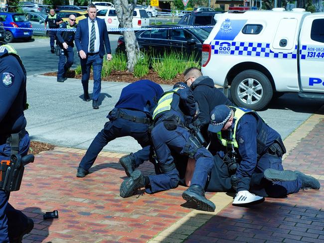 MELBOURNE AUSTRALIA - NewsWire Photos September 9, 2023: Police restrain a person at the scene of a shooting. Gavin Preston, an infamous Melbourne crime figure, was killed in an ambush shooting at a shopping centre in Keilor East, about 15 kms north-west of Melbourne on Saturday. Two shooters are believed to still be on the run.Picture: NCA NewsWire/Luis Ascui