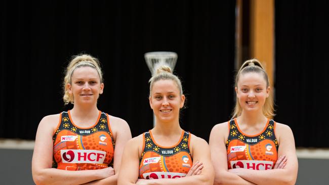 Giants players (l-r) Jo Harten, Jamie-Lee Price and Sophie Dwyer wearing the club's First Nations Round dress designed by Gamilaroi woman Krystal Dallinger.