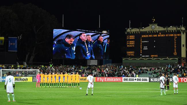 Socceroo players observe a minutes silence before the 2018 FIFA World Cup qualifierwhile Saudi Arabia players stand and wait for the start of the game at the Adelaide Oval. Picture: Daniel Kalisz/Getty