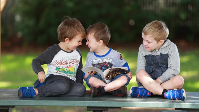 Archer, 4, Max, 3 and Micah, 4, find joy and friendship in books. Picture: Claudia Baxter/AAP