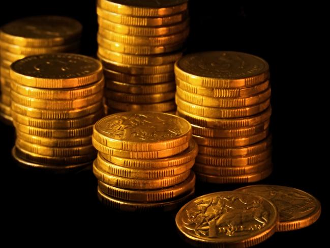 Stacks of Australian dollars in golden light, on black background. money generic