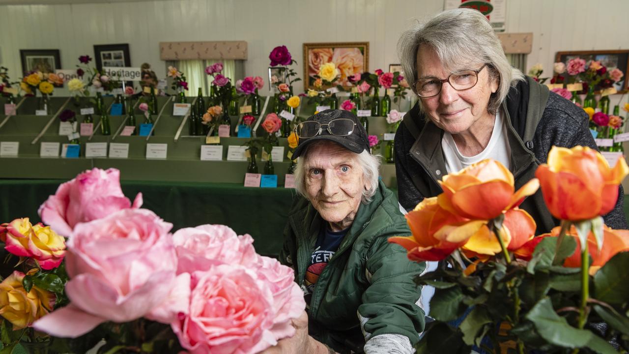 Wayne Leonard (left) and Don McKillop admire the entries of the 2022 Spring Champion Rose Show at the Rose Cottage in the Queensland State Rose Garden, Saturday, October 8, 2022. Picture: Kevin Farmer