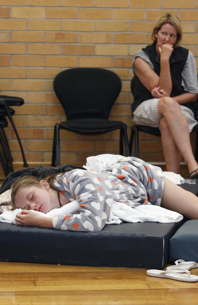 Families rest as they wait out the fires in Cobden. Picture: David Caird