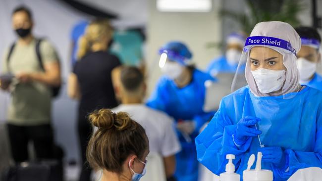 A health worker looks on at the Histopath pre-departure Covid-19 testing clinic at Sydney International airport. Picture: Getty