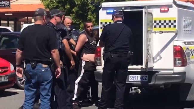 Police handcuff fugitive Luke Brandon, moments after an alleged carjacking at the Goolwa Village Shopping Centre. Picture: Nine News