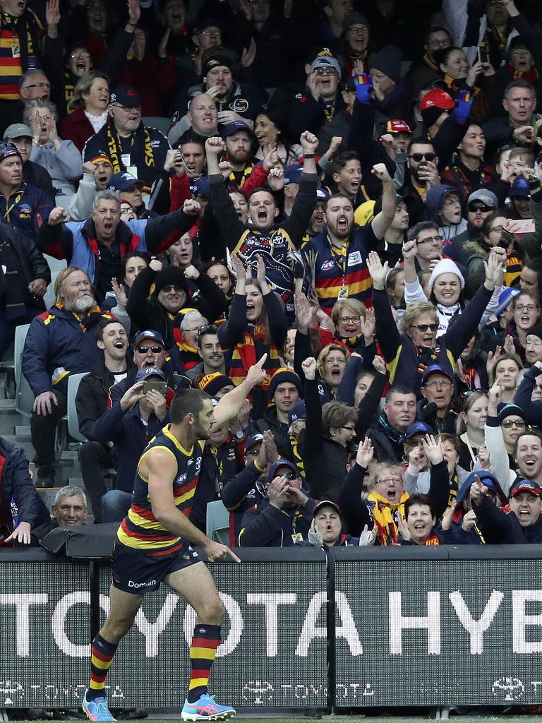 Adelaide captain celebrates with fans after scoring a goal. Picture SARAH REED