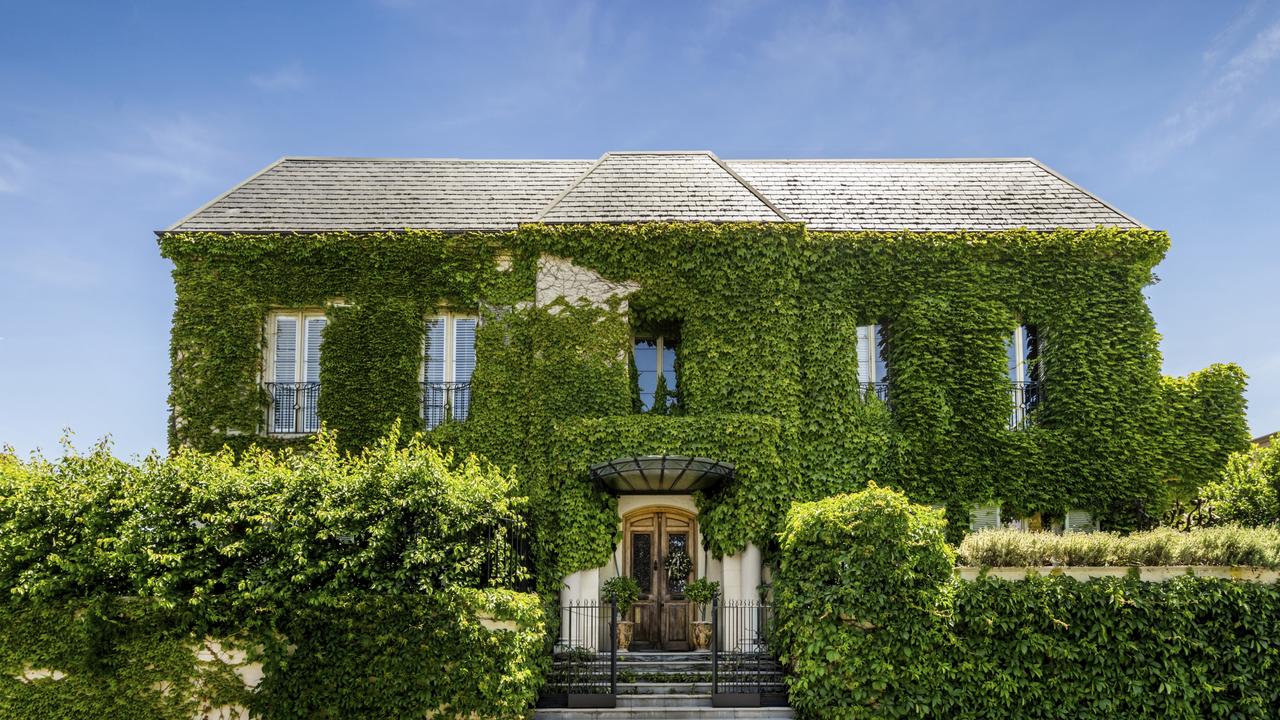 The mansion’s French chateau-inspired facade is covered in ivy.