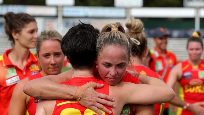 Suns players leave the field dejected after being defeated during the AFLW semi final 4 match between the Fremantle Dockers and Gold Coast Suns at Fremantle Oval in Perth, Saturday, March 21, 2020. (AAP Image/Richard Wainwright)