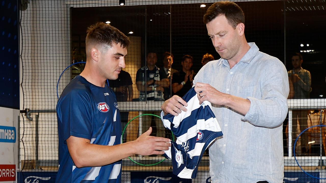 Shaun Mannagh receives his jumper from James Saker. Picture: Michael Willson/AFL Photos via Getty Images