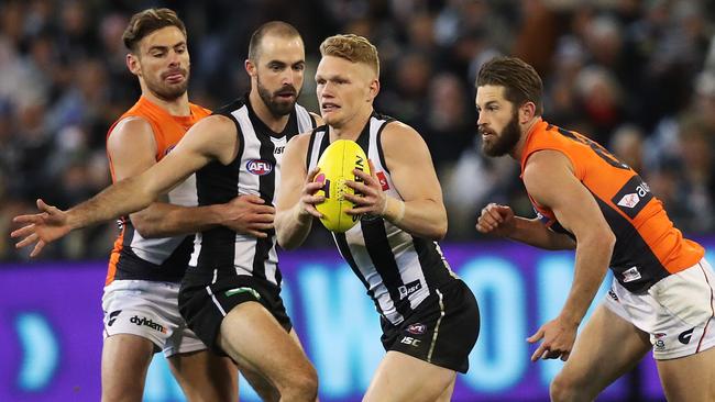 Former Giant Adam Treloar gets away from Callan Ward. Picture: Phil Hillyard