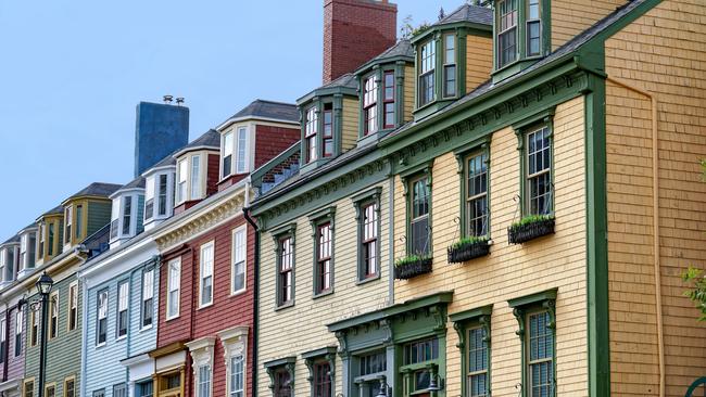 Row of colourful Victorian clapboard houses in the city.