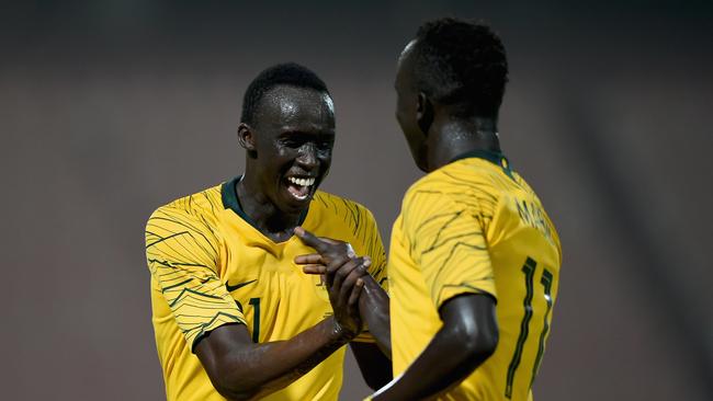 Awer Mabil (right) celebrates with Thomas Deng after scoring Australia’s fourth goal against Kuwait. Picture: Getty Images