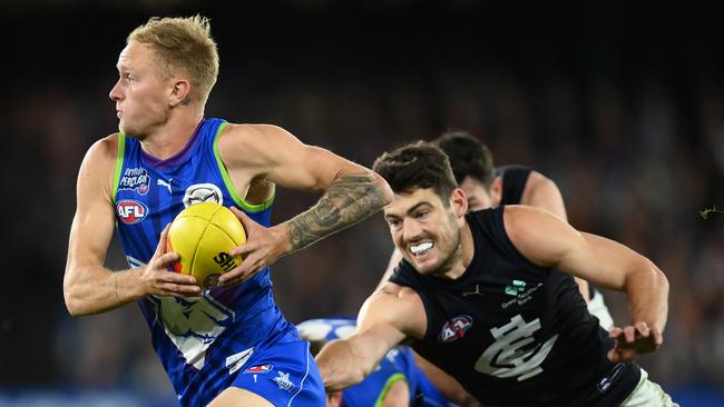 MELBOURNE, AUSTRALIA - APRIL 07: Jaidyn Stephenson of the Kangaroos is tackled by George Hewett of the Blues  during the round four AFL match between North Melbourne Kangaroos and Carlton Blues at Marvel Stadium, on April 07, 2023, in Melbourne, Australia. (Photo by Quinn Rooney/Getty Images)