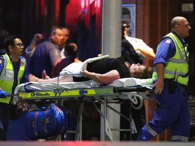 Louisa Hope is taken from the Lindt Cafe on a stretcher suffering an injury to her foot after the siege had ended. Picture: Getty