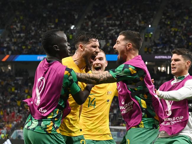 The Socceroos celebrate their win over Denmark, the first time the team has won successive matches at the World Cup. Picture: Claudio Villa/Getty Images