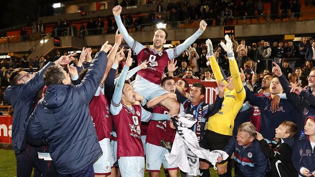 APIA Leichhardt players celebrate their shock victory over the current A-League champions.