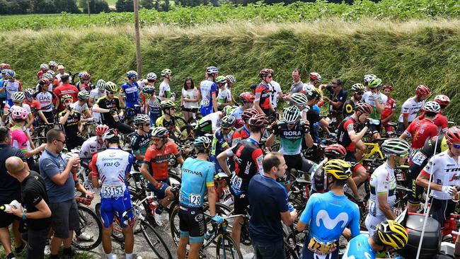 Riders wait for the stage to resume.