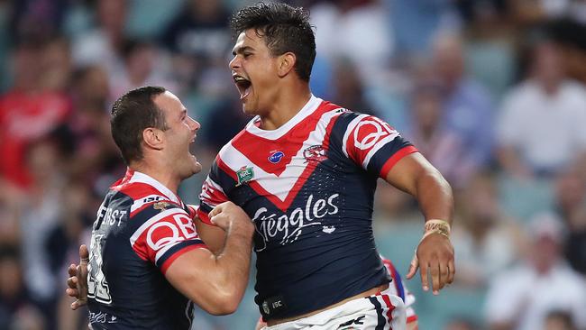 Latrell Mitchell celebrates with Roosters teammate Boyd Cordner after scoring a try against the Knights at Allianz Stadium. Picture: Brett Costello