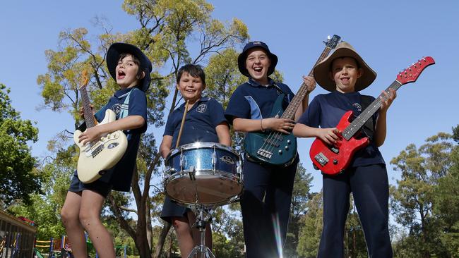 Kinglake West Primary School students Sonny, Robert, Camryn and Cohen enjoy the musical instruments generously donated from the public. Picture: George Salpigtidis