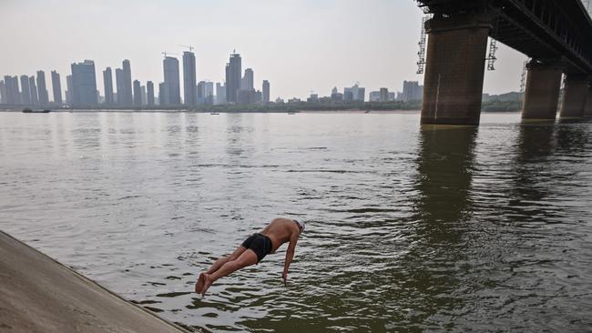 A man jumps into the Yangtze river in Wuhan, China's central Hubei province on April 16. China says it has largely brought the coronavirus under control within its borders.