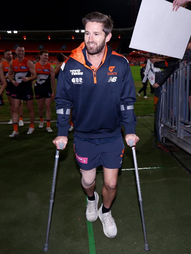 Ward leads GWS from the field on crutches.