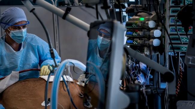 Healthcare workers attend to a coronavirus patient at the Intensive Care Unit (ICU) of Sao Joao Hospital in Porto. Picture: AFP