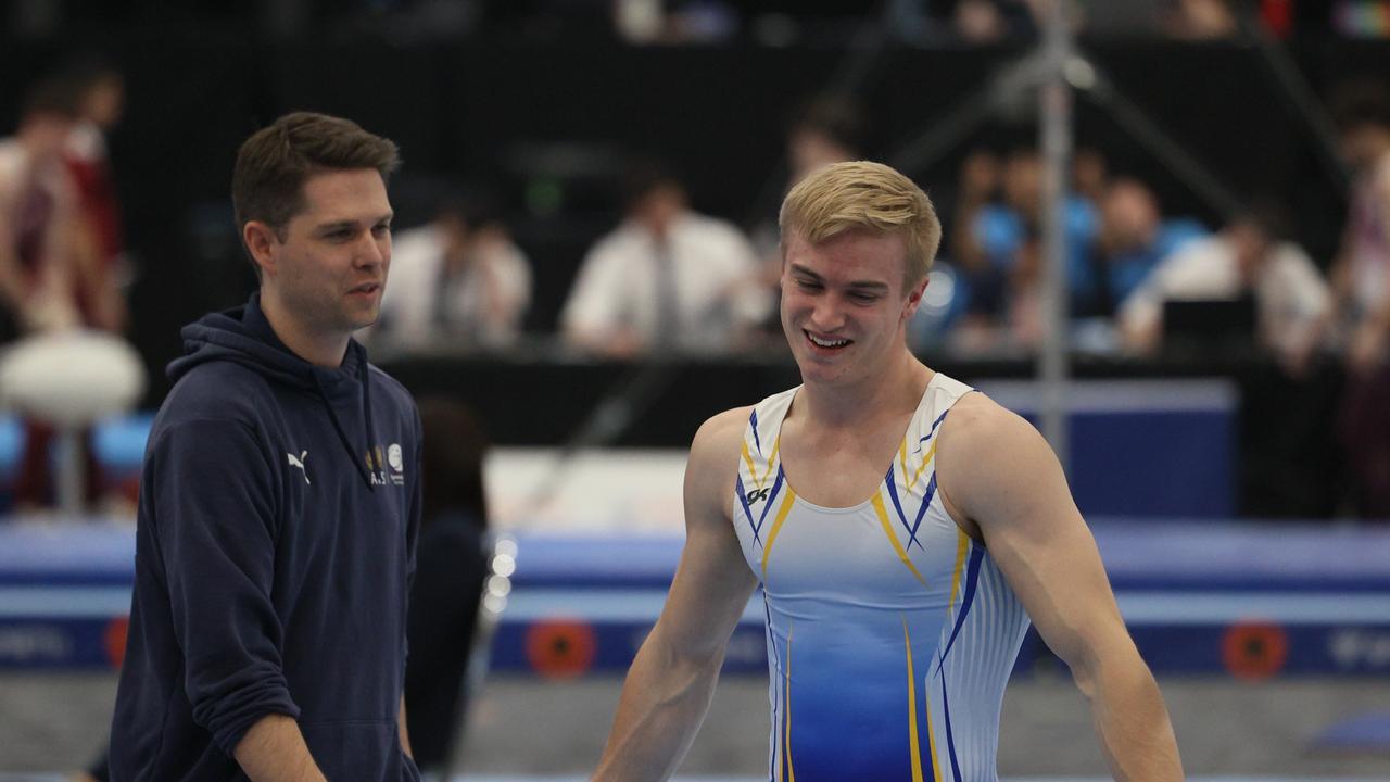 Sean Wilson (left) talks tactics with one of his gymnasts. Picture: WinkiPoP Media