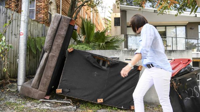 Just another day in Sydney. A resident is forced to navigate through dumped rubbish on Old South Head Rd, Bondi.