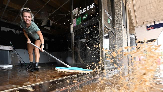 Laani Winkler 25, helps clean friend Kylie Gilmore’s Civic Hotel in Lismore’s CBD, flood-ravaged for the second time in weeks. Picture: Lyndon Mechielsen