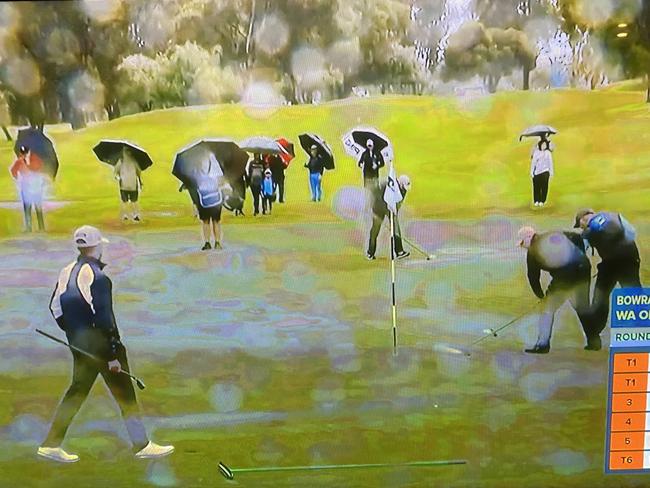 Screenshot of officials using squeegees on the greens after heavy rain at the WA Open at Mandurah. Photo: Supplied