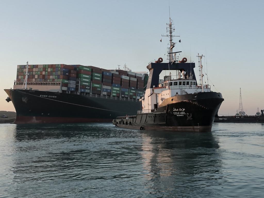 Tugboats pull the Panama-flagged Ever Given out of its sideways position, where it had been impeding traffic across Egypt's Suez Canal waterway for almost a week. Picture: SUEZ CANAL AUTHORITY / AFP