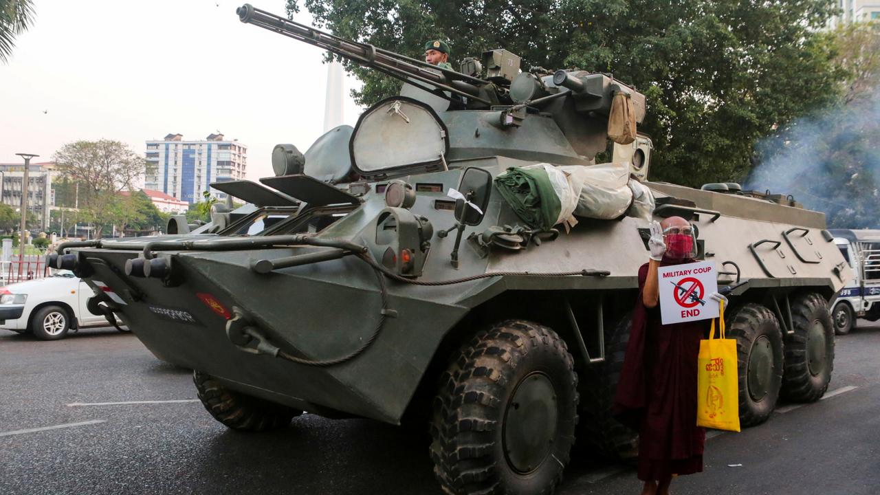 A Buddhist monk holds a protest next to a tank in Yangon in Myanmar. Picture: Reuters/Stringer