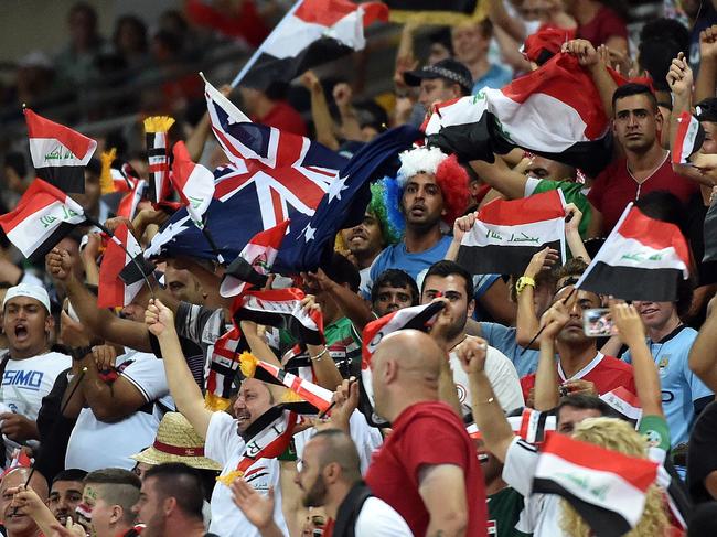Iraq's fans celebrate after their team scored against Jordan during the first round Asian Cup football match between Jordan and Iraq at the Suncorp Stadium in Brisbane on January 12, 2015. AFP PHOTO / Saeed KHAN IMAGE RESTRICTED TO EDITORIAL USE - STRICTLY NO COMMERCIAL USE