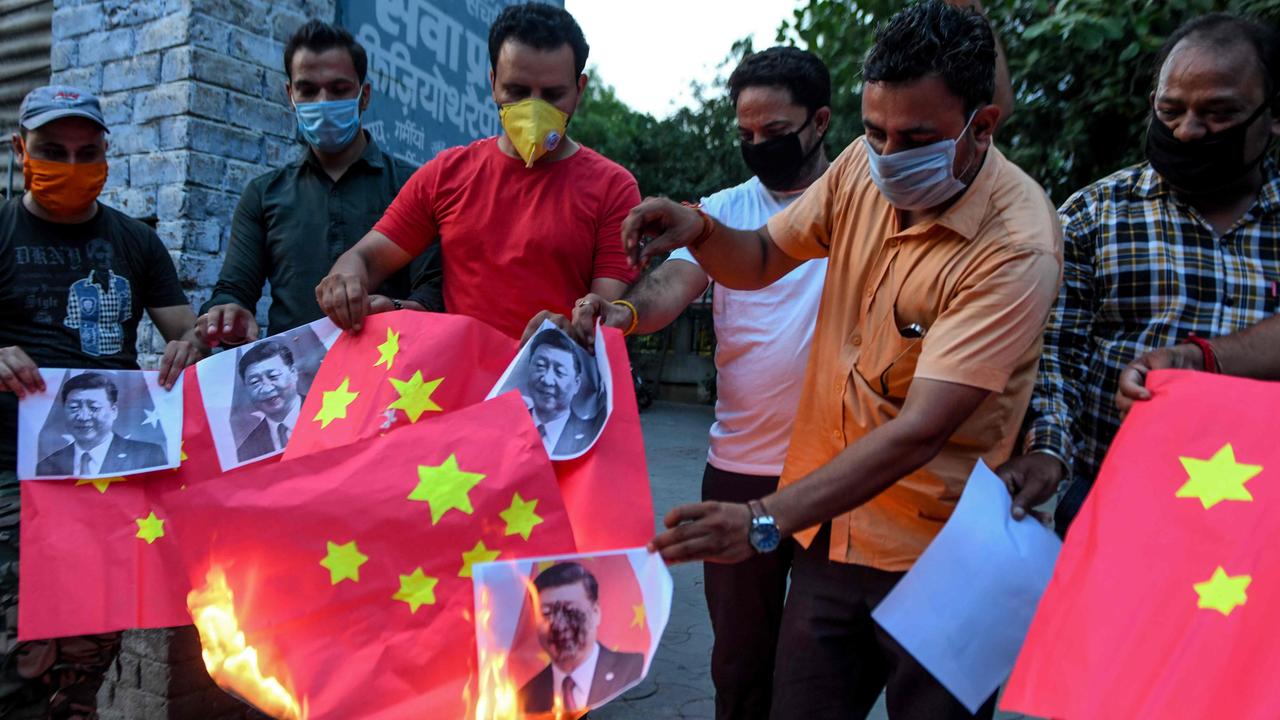 Activists burn Chinese flags and posters of Chinese President Xi Jinping during an anti-China protest in India after a violent border brawl that left at least 20 Indian soldiers dead. Picture: AFP.