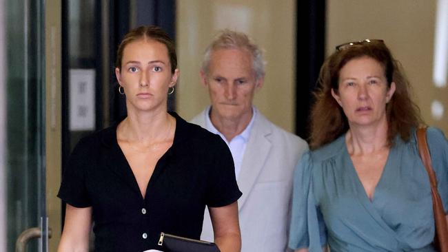 Arabella Cignetti pictured (in black) as she leaves downing centre court, with her father behind her.