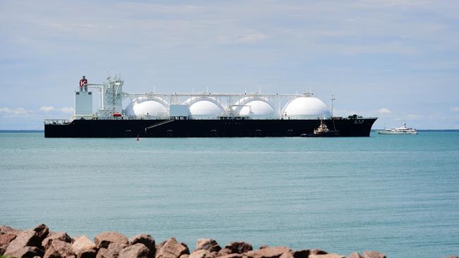 A massive cargo ship with natural gas dwarfs a yacht in the Darwin Harbour. Picture: Justin Kennedy