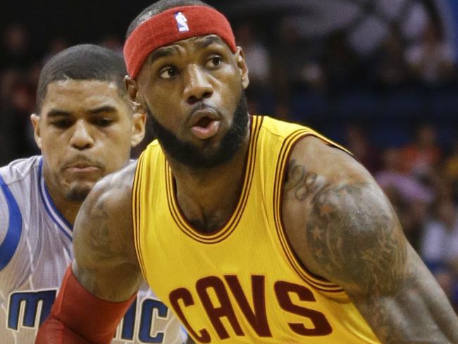 Cleveland Cavaliers' LeBron James (23) drives past Orlando Magic's Tobias Harris, left, during the first half of an NBA basketball game, Friday, Dec. 26, 2014, in Orlando, Fla. (AP Photo/John Raoux)