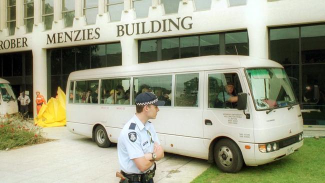 Victorian police officers and witnesses leave Monash University after the 2002 shooting.`