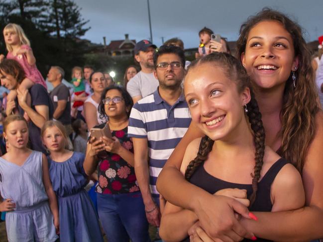 Mysha and Chloe Ibarbuni waiting for the appearance of Santa, at the 2019 Christmas Choral Concert at Manly Oval. Picture: Phillip Rogers