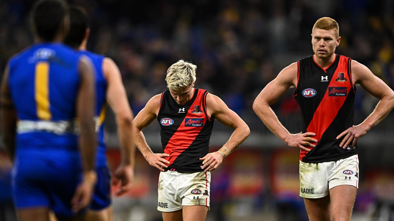 PERTH, AUSTRALIA - JUNE 24: Matt Guelfi and Peter Wright of the Bombers look dejected after their loss during the 2022 AFL Round 15 match between the West Coast Eagles and the Essendon Bombers at Optus Stadium on June 24, 2022 in Perth, Australia. (Photo by Daniel Carson/AFL Photos via Getty Images)