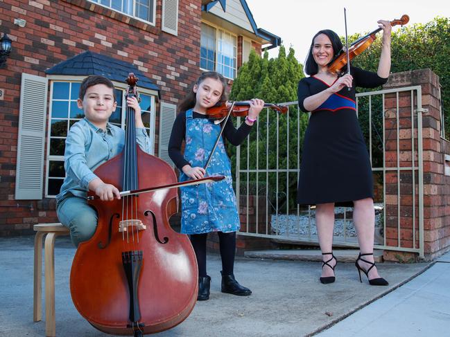 Victoria Jacono-Gilmovich with her children Hugo, 6, and Estelle, 8, from Five Dock, who will be playing the Last Post on Saturday as part of the Anzac Day Driveways At Dawn initiative. Picture: Justin Lloyd